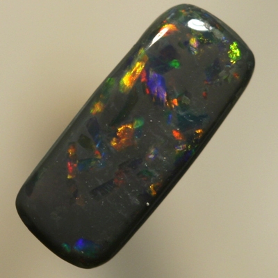SOLID BLACK OPAL Sparkles of red between blues with a touch of gold